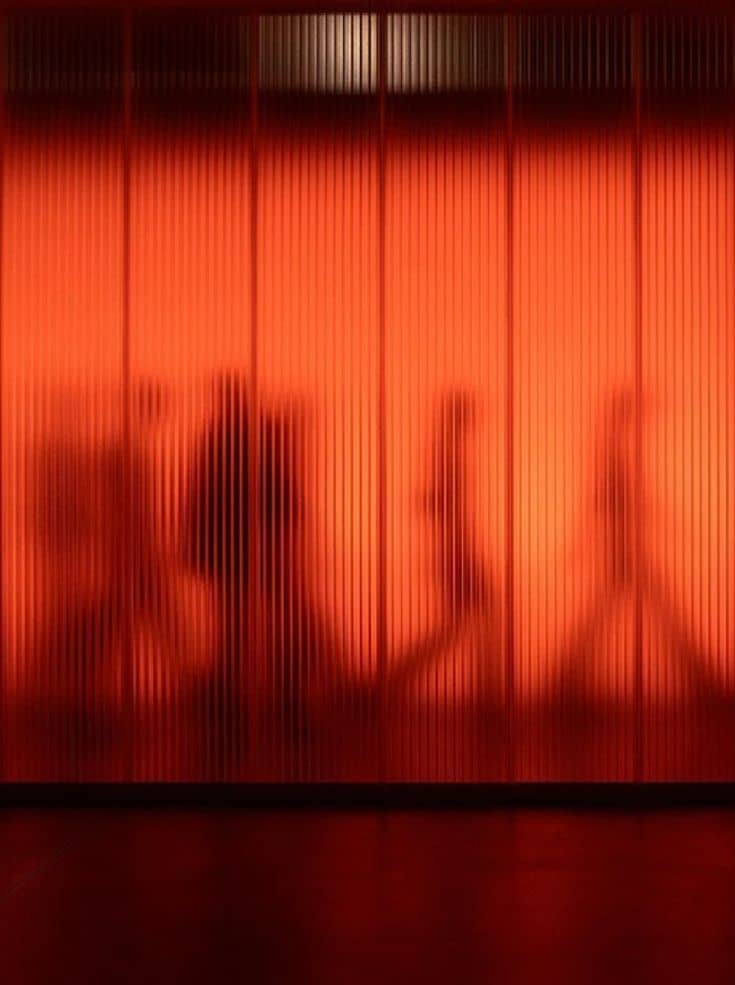 People seen through an orange translucent screen